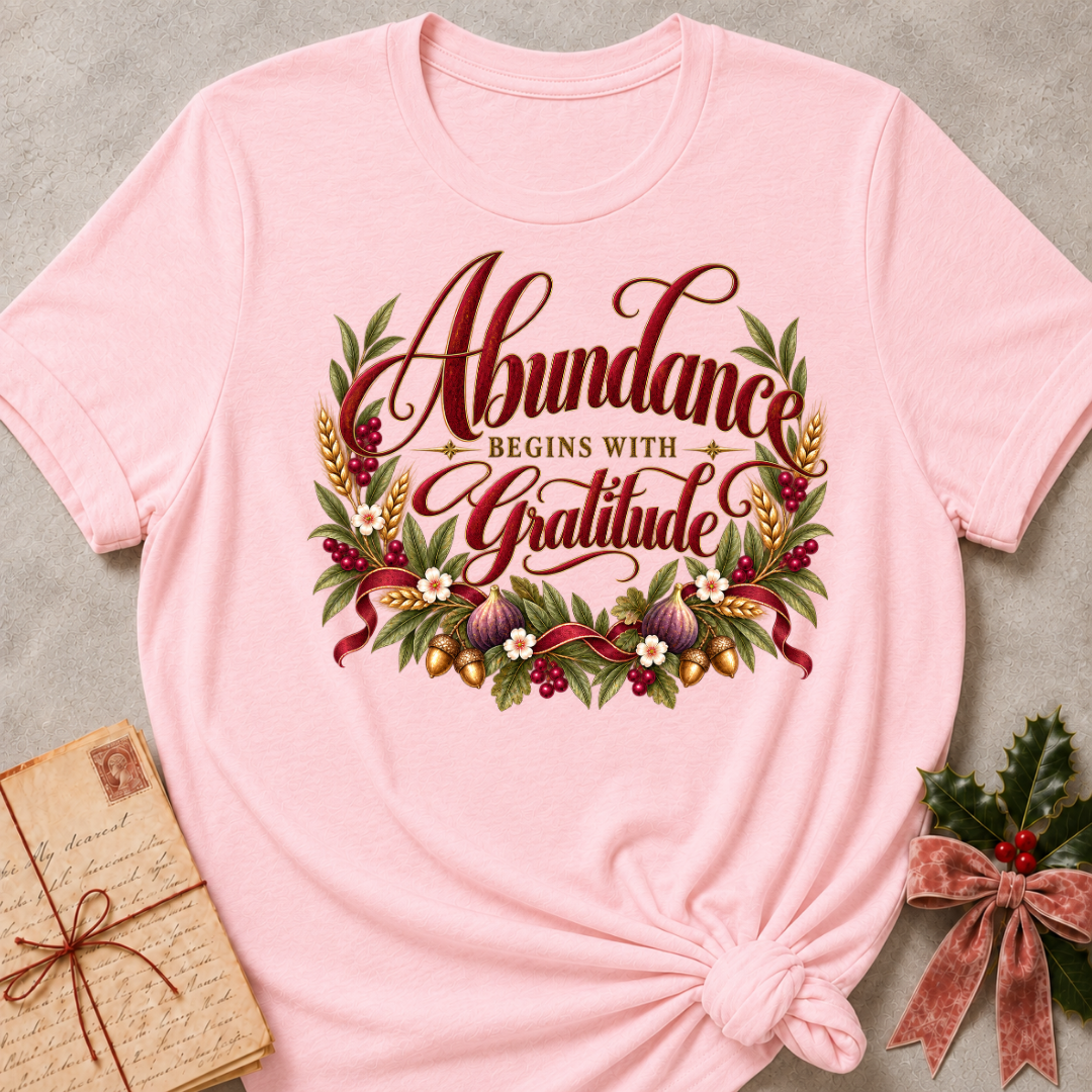 Pink relaxed fit tee with Abundance Begins with Gratitude script, golden wheat, figs, acorns and a ruby ribbon