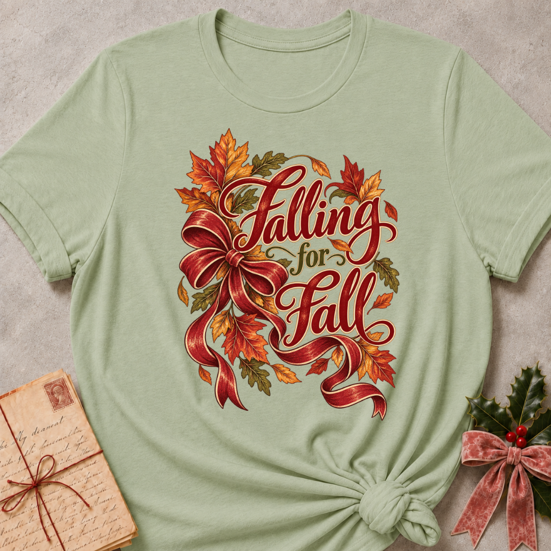 Sage relaxed fit tee with Falling for Fall script, an oversized burgundy bow and swirling autumn leaves