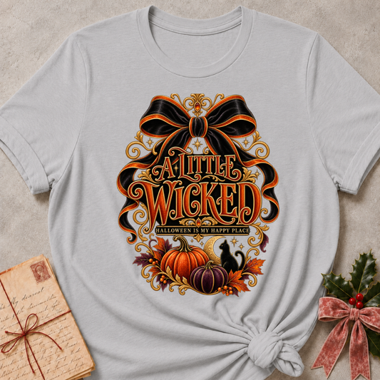 Athletic Heather A Little Wicked tee with an oversized black bow, harvest pumpkins and a black cat under a crescent moon