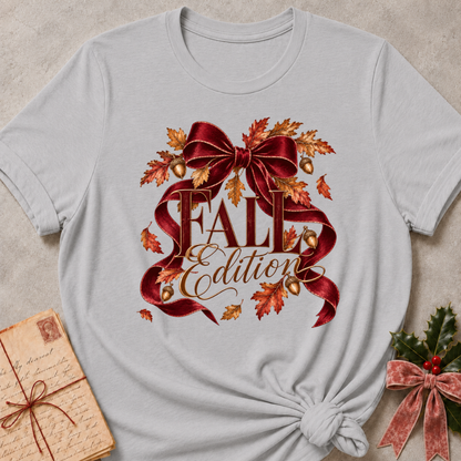 Athletic heather grey women's relaxed tee with a Fall Edition script design wrapped in a burgundy satin bow with autumn leaves and acorns