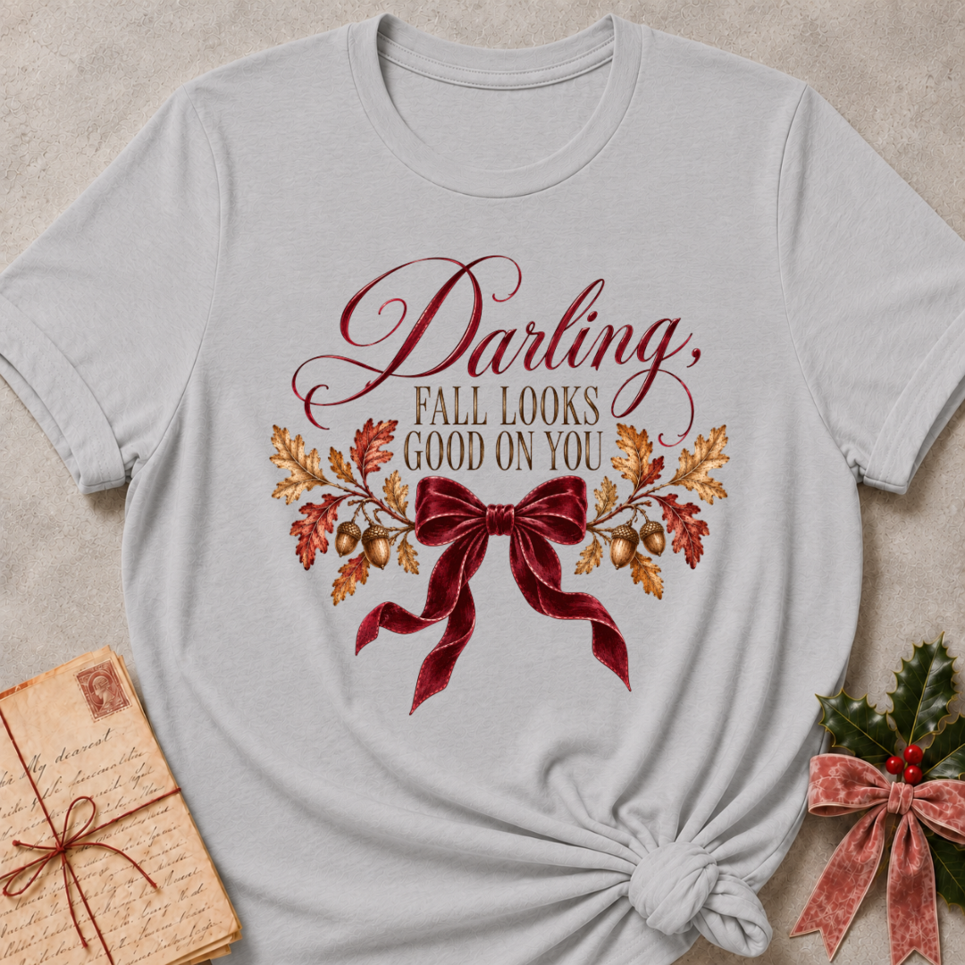 Athletic heather grey women's relaxed tee with a Darling, Fall Looks Good On You script design with a burgundy velvet bow, oak leaves, and acorns