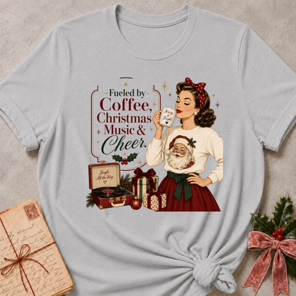 Athletic heather grey relaxed fit tee with a retro Christmas pinup and Fueled By Coffee Christmas Music and Cheer lettering