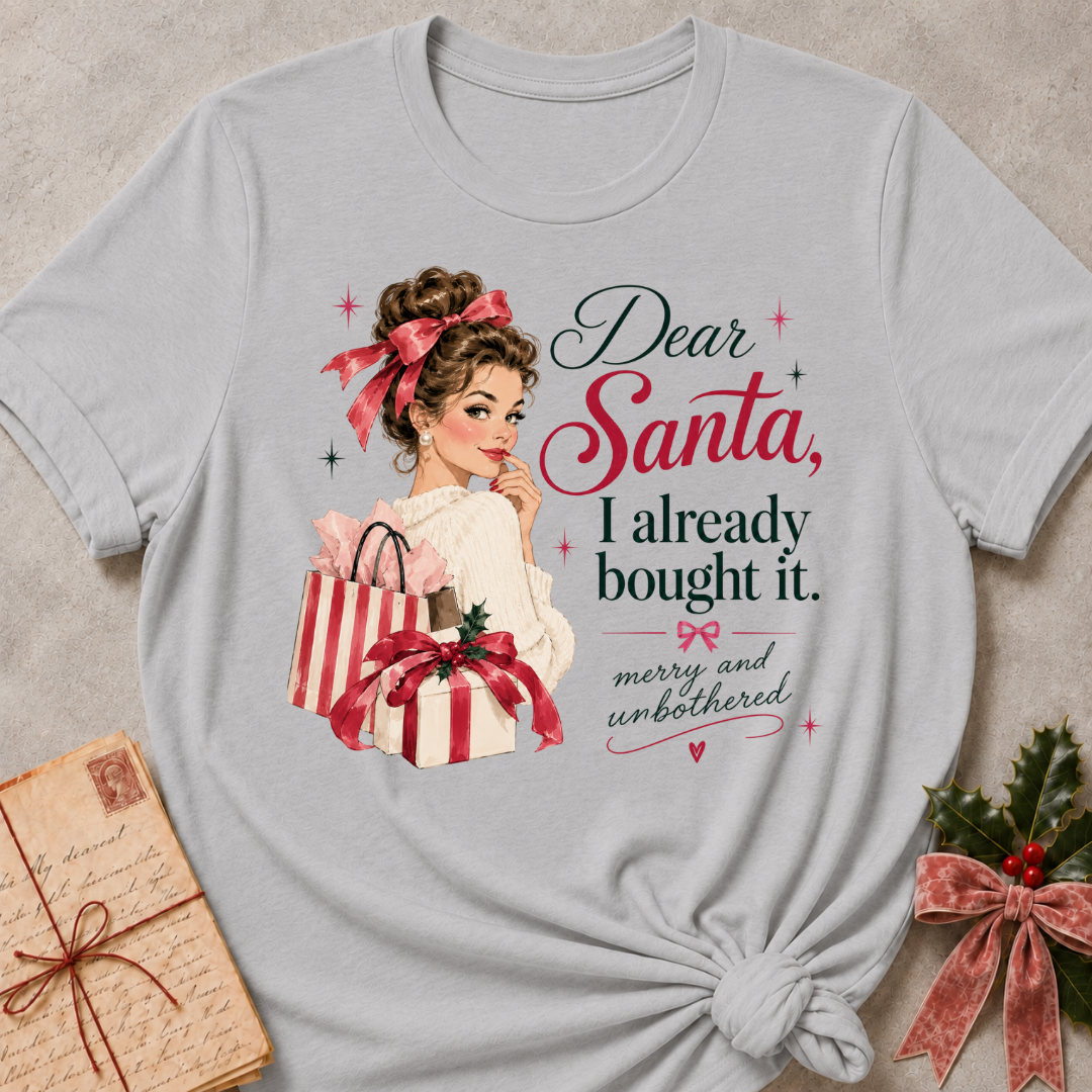 Athletic Heather relaxed fit tee with Dear Santa, I already bought it lettering, a vintage holiday shopper with striped gift boxes and red bows