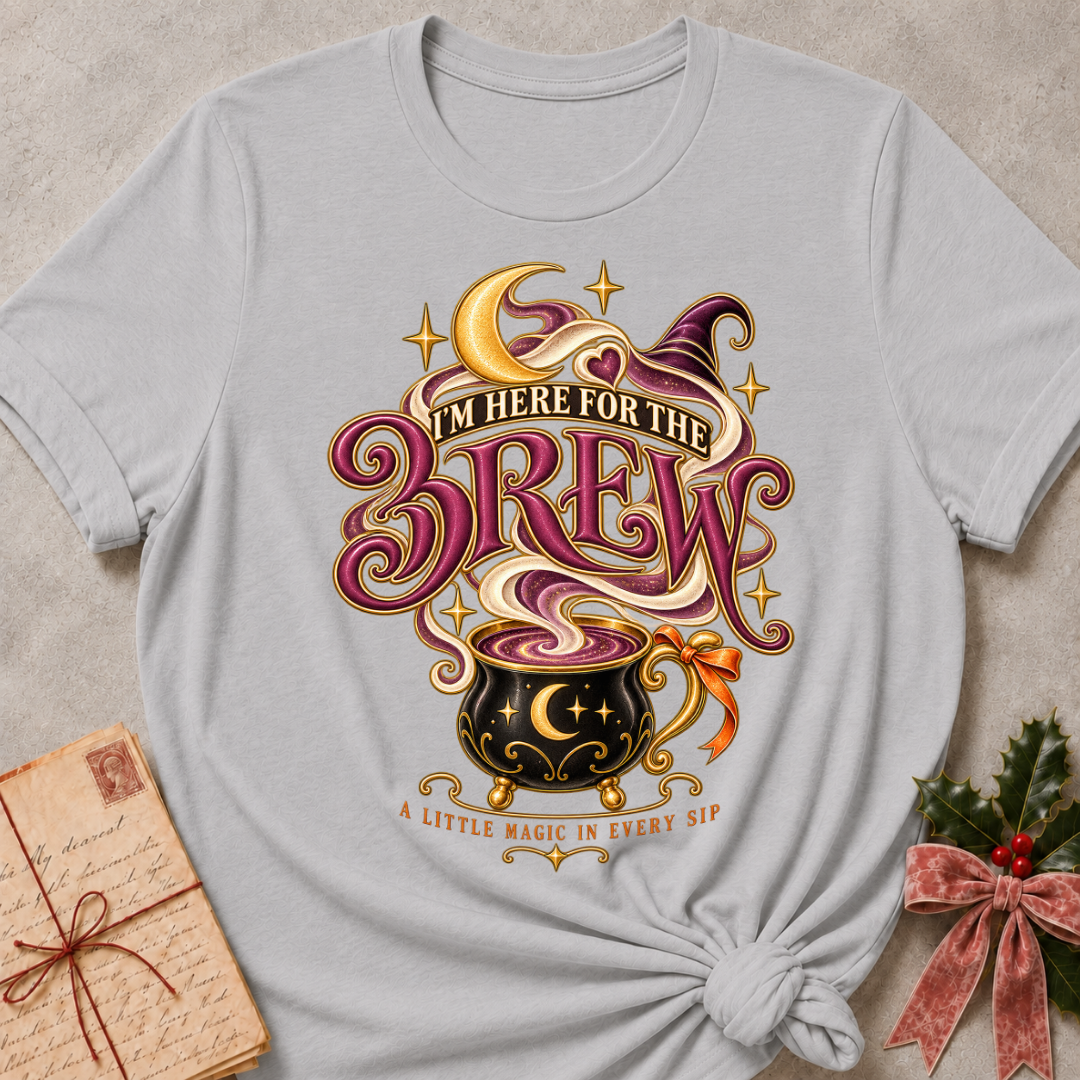 Athletic Heather I'm Here For The Brew tee with a moonlit cauldron mug, crescent moon and witch's hat in plum and gold