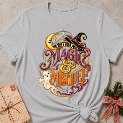 Athletic Heather A Little Magic & Mischief tee with a smiling ghost, sleepy crescent moon and witch's hat in gold and plum