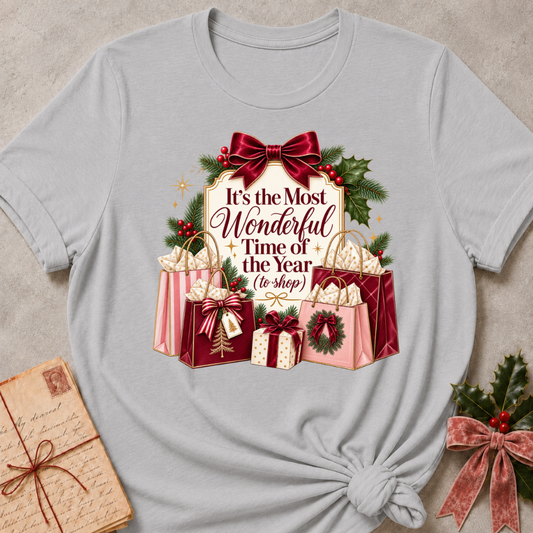 Athletic Heather relaxed fit tee with It's the Most Wonderful Time of the Year to Shop lettering, a burgundy velvet bow, holly and stacked gift bags