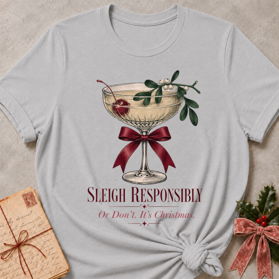 Athletic Heather relaxed fit tee with Sleigh Responsibly lettering, a vintage champagne coupe with a cherry, mistletoe and a burgundy bow
