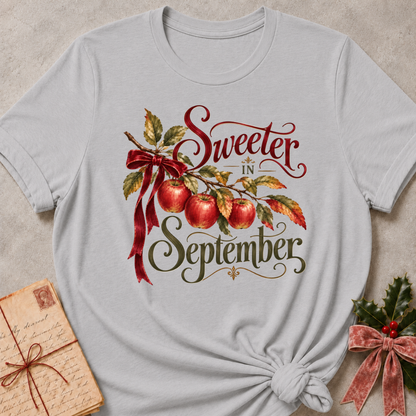 Athletic Heather relaxed fit tee with Sweeter in September script lettering, an apple branch with red apples, autumn leaves and a burgundy bow