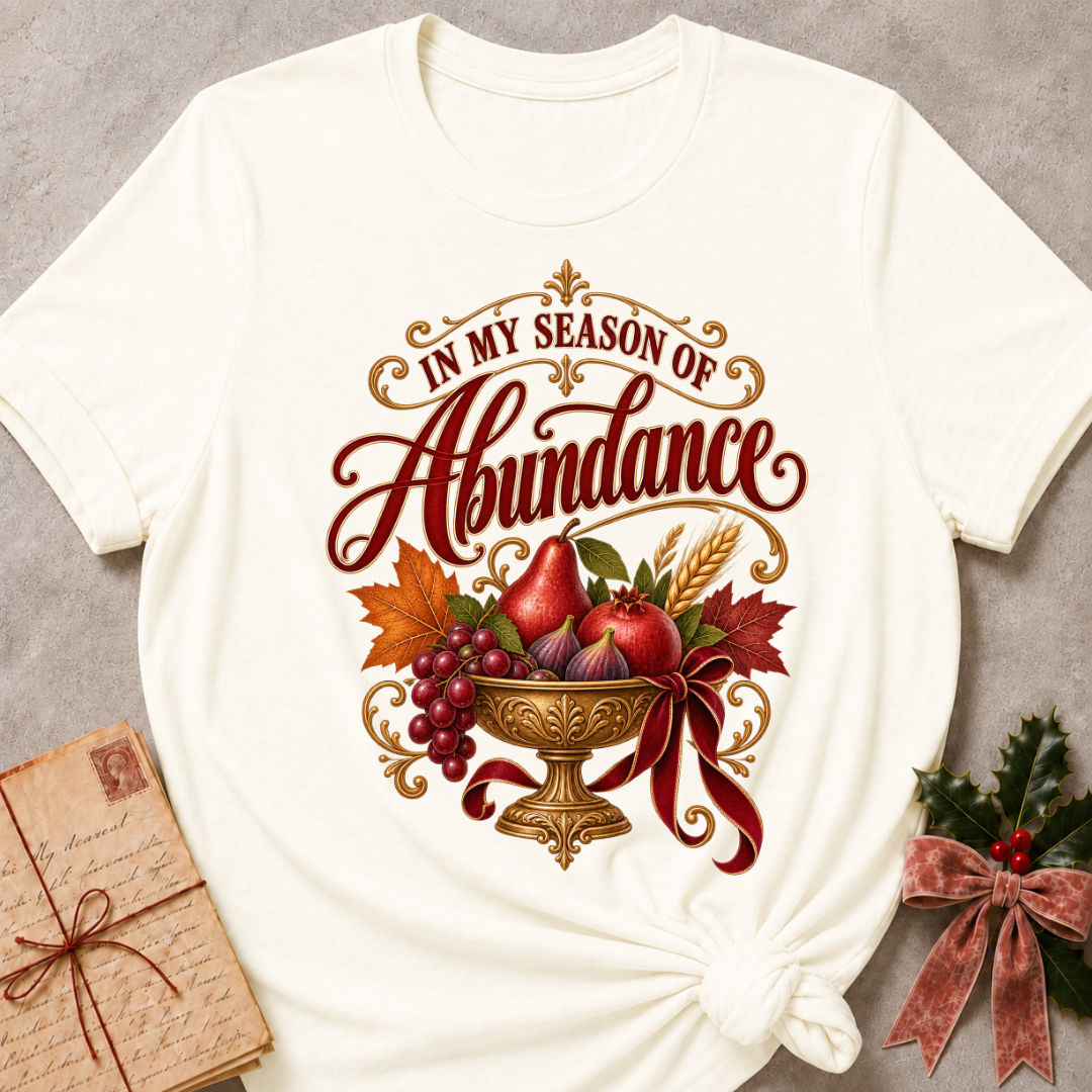 Heather Deep Teal relaxed fit tee with In My Season of Abundance script and an ornate golden bowl of pears, pomegranates, figs, grapes and wheat with a ruby bow