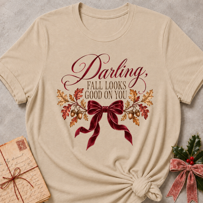 Heather stone women's relaxed tee with a Darling, Fall Looks Good On You script design with a burgundy velvet bow, oak leaves, and acorns