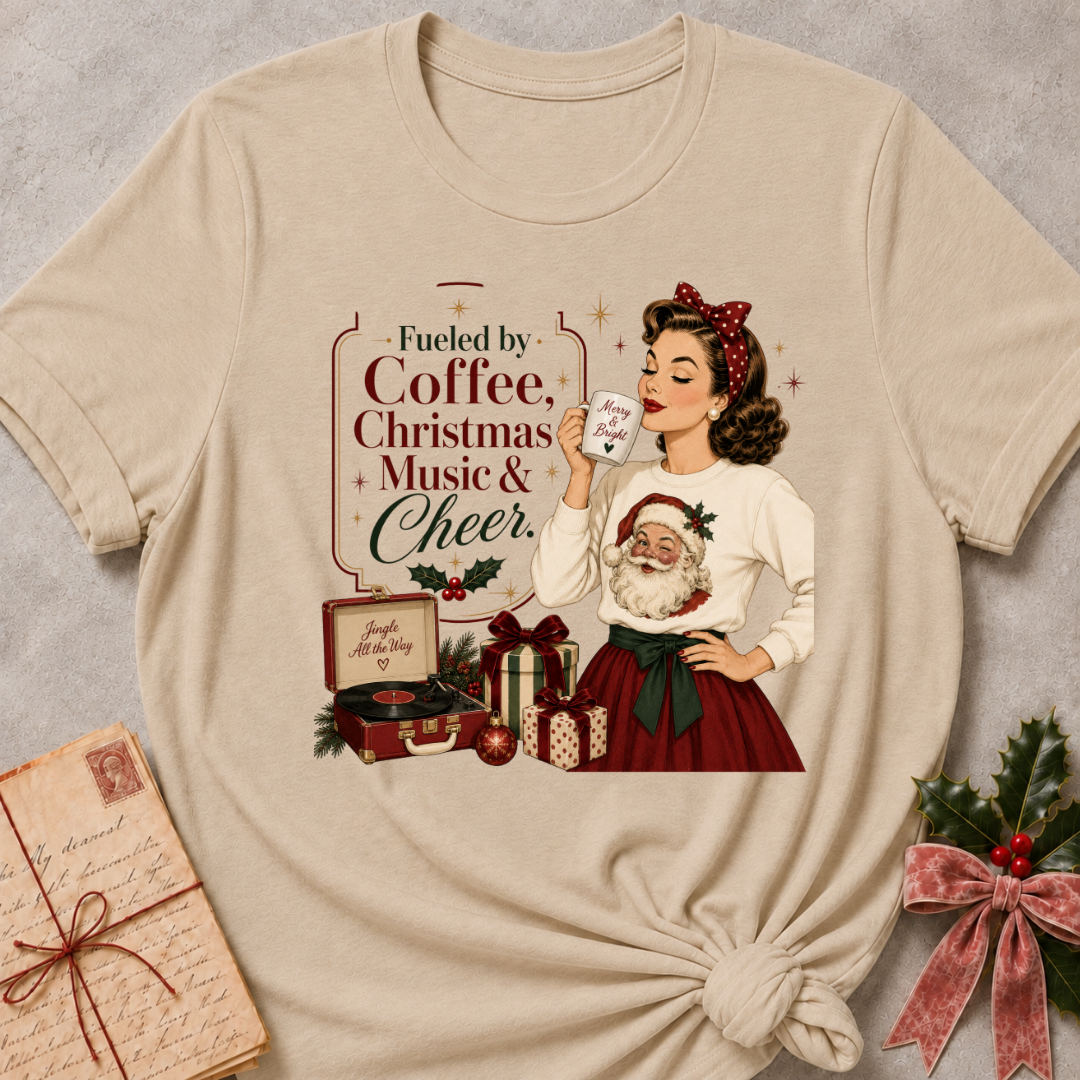 Heather stone relaxed fit tee with a retro Christmas pinup and Fueled By Coffee Christmas Music and Cheer lettering