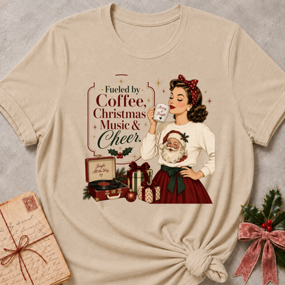Heather stone relaxed fit tee with a retro Christmas pinup and Fueled By Coffee Christmas Music and Cheer lettering