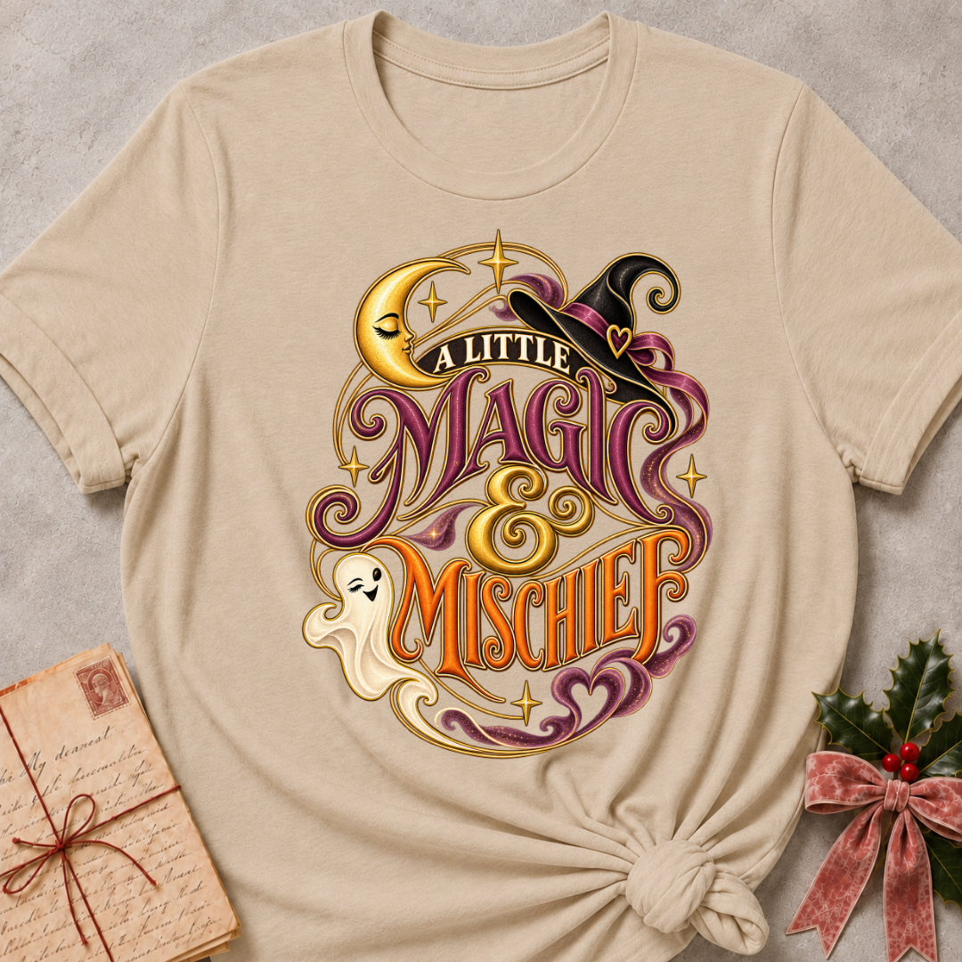 Heather Stone A Little Magic & Mischief tee with a smiling ghost, sleepy crescent moon and witch's hat in gold and plum