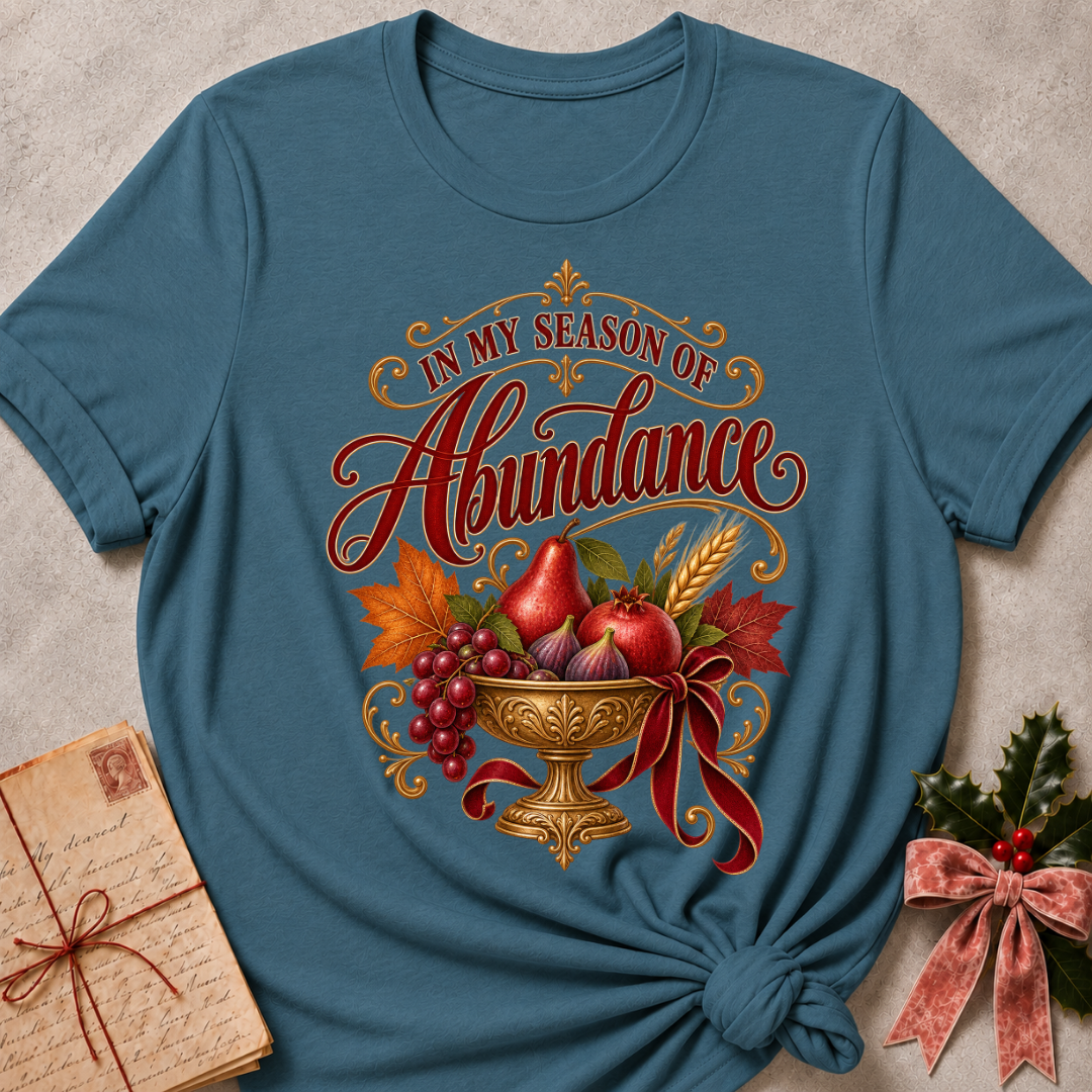 Heather Stone relaxed fit tee with In My Season of Abundance script and an ornate golden bowl of pears, pomegranates, figs, grapes and wheat with a ruby bow