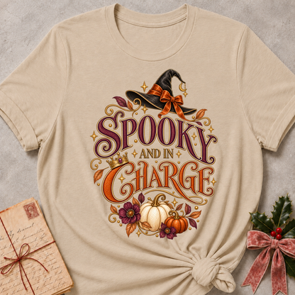 Heather Stone Spooky and In Charge tee with a bow tied witch's hat, gold crown, white pumpkins and plum blooms