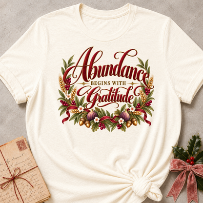 Natural relaxed fit tee with Abundance Begins with Gratitude script, golden wheat, figs, acorns and a ruby ribbon
