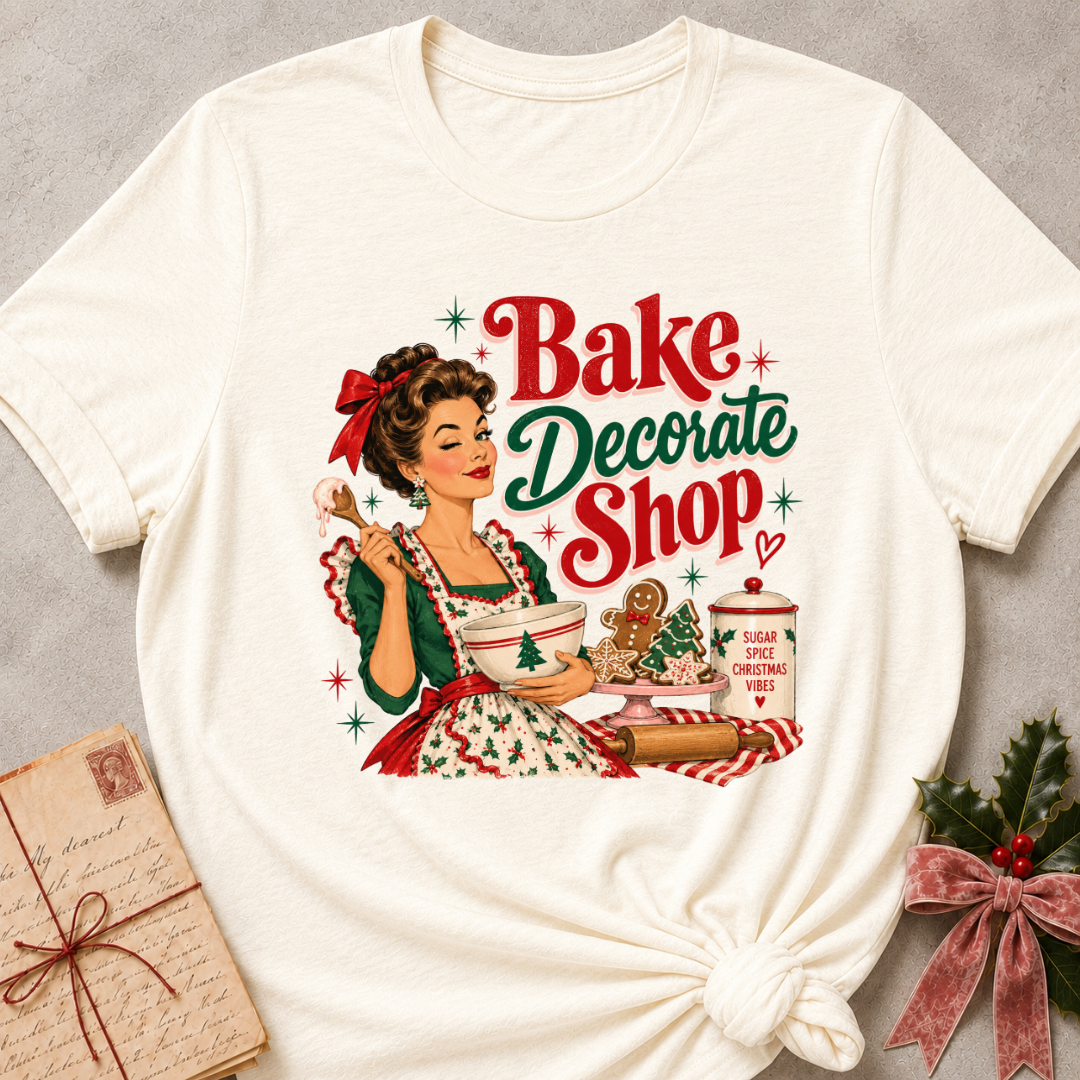 Natural cream relaxed fit tee with a winking retro baker and Bake Decorate Shop lettering