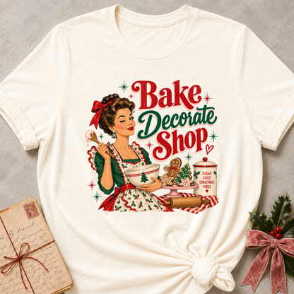 Natural cream relaxed fit tee with a winking retro baker and Bake Decorate Shop lettering