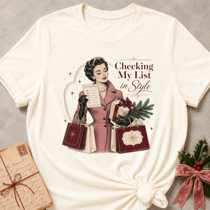 Natural relaxed fit tee with Checking My List in Style lettering, a vintage woman in a rose coat holding her list and burgundy shopping bags