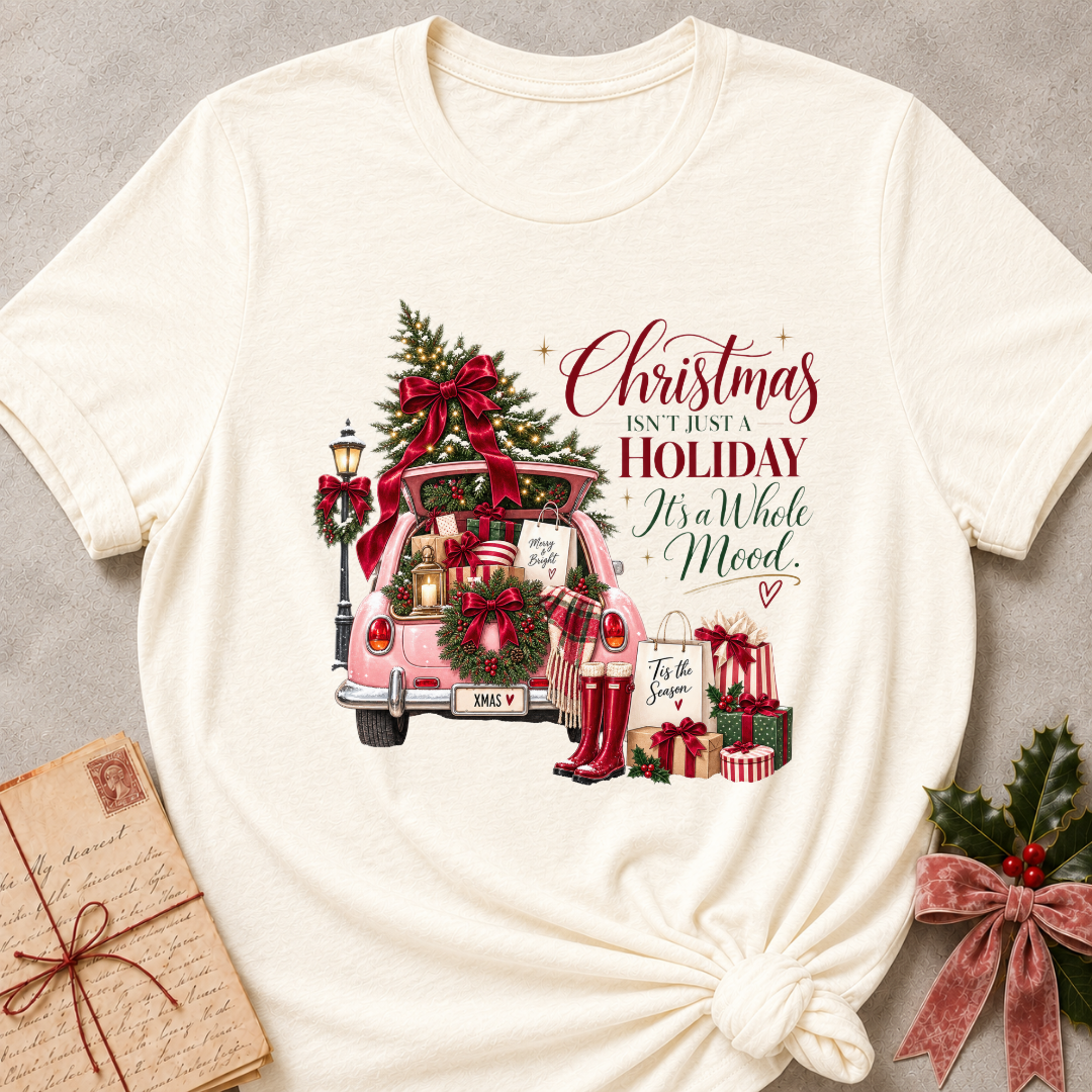 Natural cream relaxed fit tee with a pink Christmas truck full of gifts and Christmas Isn't Just A Holiday It's A Whole Mood lettering
