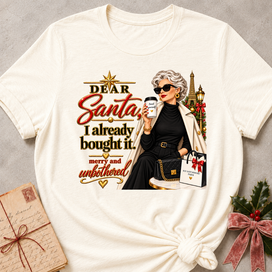 Natural relaxed fit tee with Dear Santa, I already bought it lettering, a merry and unbothered shopper in sunglasses with an iced coffee and gift bags