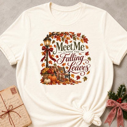 Natural relaxed fit tee with Meet Me Under the Falling Leaves lettering, a glowing lamppost, park bench, pumpkins and drifting maple leaves