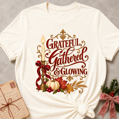 Natural Grateful, Gathered and Glowing tee with a candlelit bow, pumpkins and autumn leaves