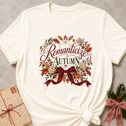 Natural relaxed fit tee with Romanticize Autumn script lettering, autumn leaves, cream blooms and a burgundy velvet bow