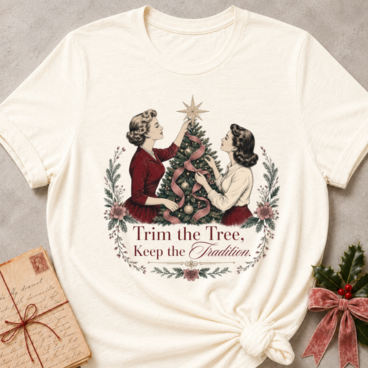 Natural cream relaxed fit tee with two vintage women trimming a Christmas tree and Trim the Tree Keep the Tradition lettering