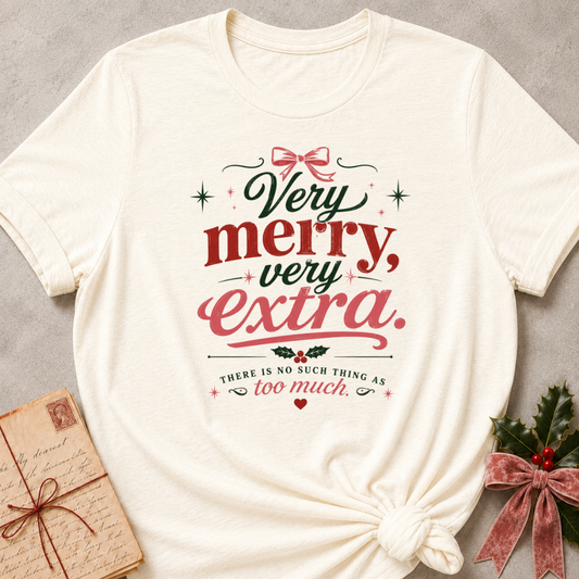 Natural relaxed fit tee with Very Merry, Very Extra retro lettering, a pink bow, holly and scattered stars