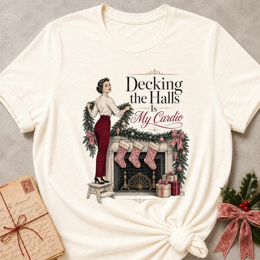 Natural relaxed fit tee with Decking the Halls Is My Cardio lettering, a vintage woman hanging garland above a mantel of stockings, bows and gifts