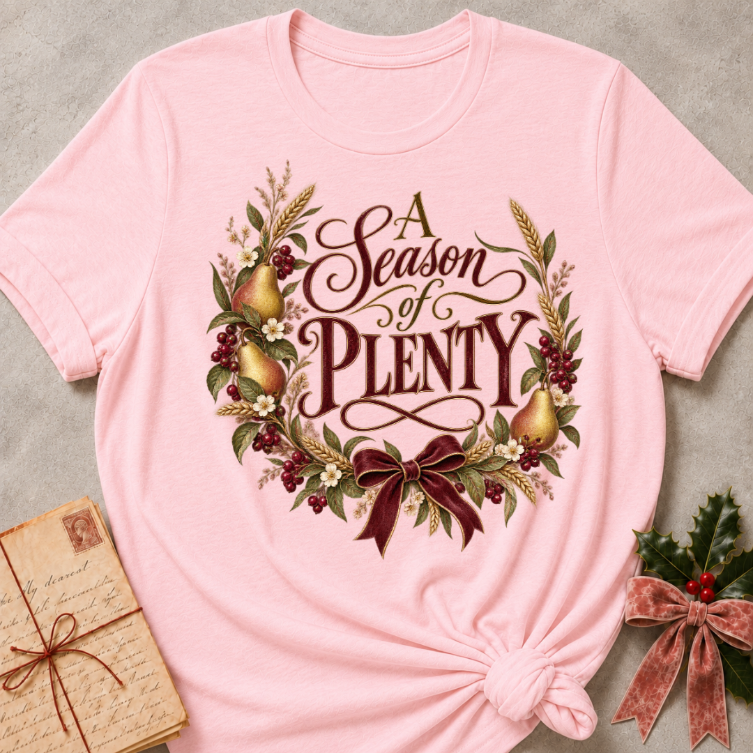 Pink relaxed fit tee with A Season of Plenty script, golden pears, wheat, berries and a burgundy bow