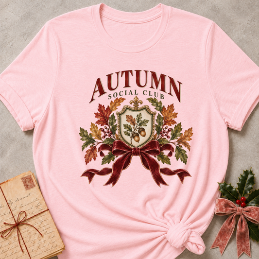 Pink relaxed fit tee with an Autumn Social Club crest, oak leaves, acorns and a burgundy bow