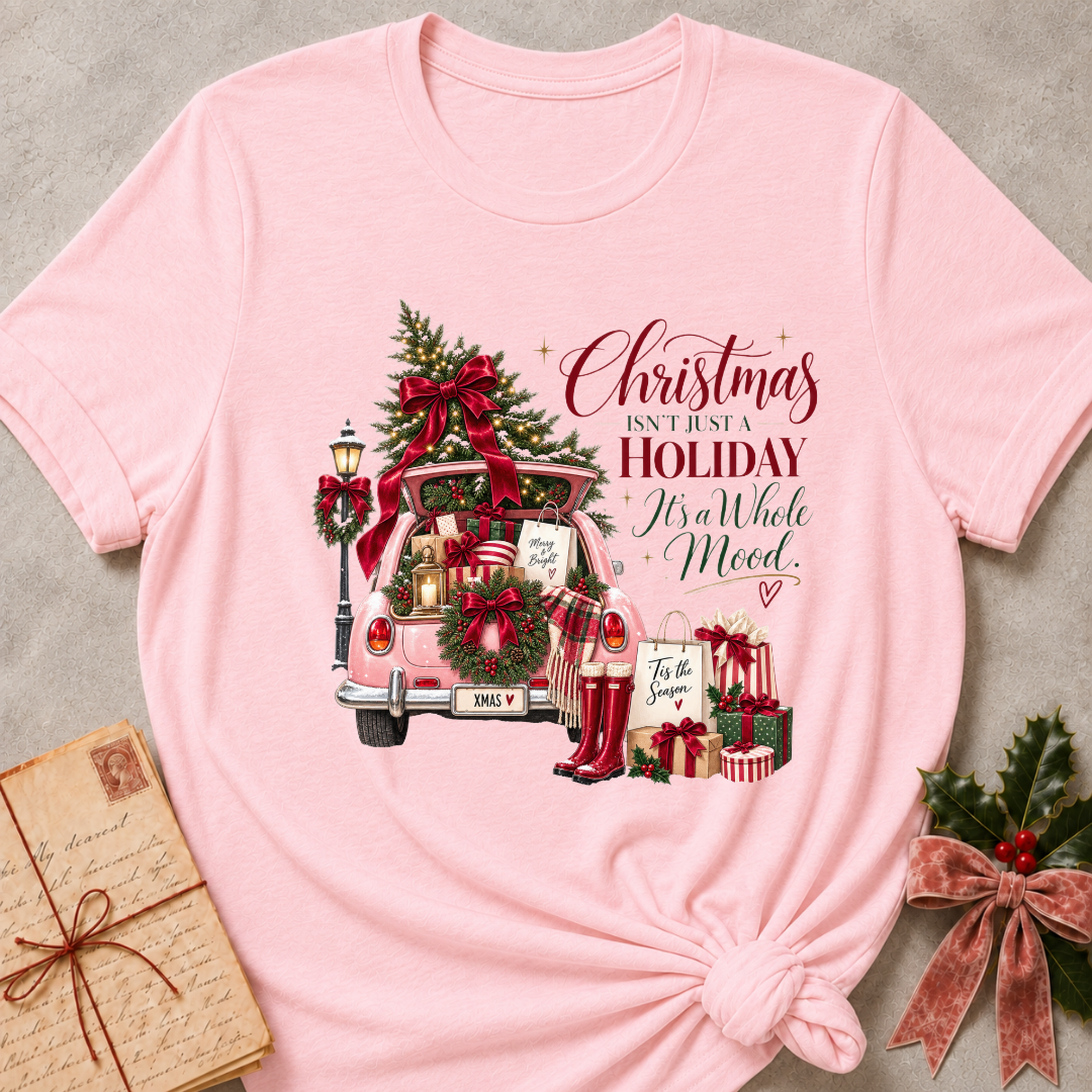 Soft pink relaxed fit tee with a pink Christmas truck full of gifts and Christmas Isn't Just A Holiday It's A Whole Mood lettering