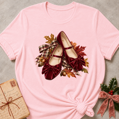 Pink relaxed fit tee with a row of autumn boots, falling leaves and a bow