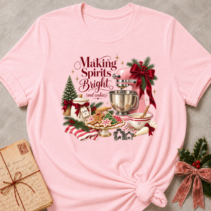Soft pink relaxed fit tee with a vintage Christmas baking scene and Making Spirits Bright lettering