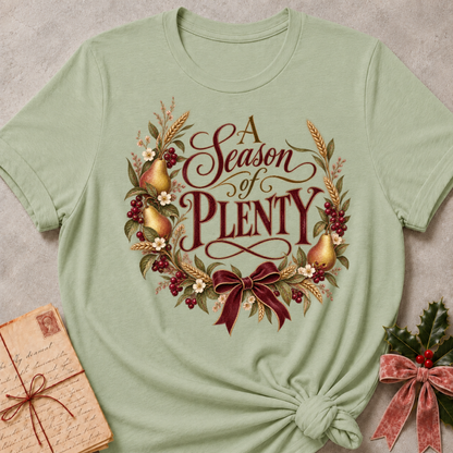 Sage relaxed fit tee with A Season of Plenty script, golden pears, wheat, berries and a burgundy bow