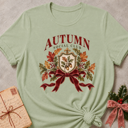 Sage relaxed fit tee with an Autumn Social Club crest, oak leaves, acorns and a burgundy bow