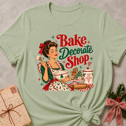 Sage green relaxed fit tee with a winking retro baker and Bake Decorate Shop lettering
