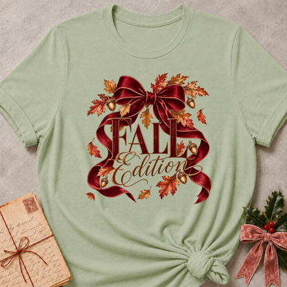 Sage women's relaxed tee with a Fall Edition script design wrapped in a burgundy satin bow with autumn leaves and acorns