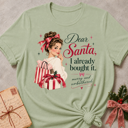 Sage relaxed fit tee with Dear Santa, I already bought it lettering, a vintage holiday shopper with striped gift boxes and red bows