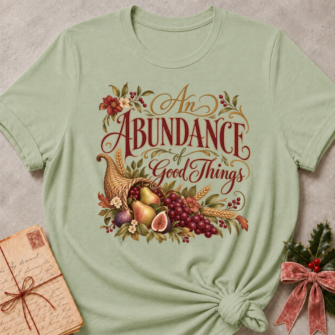Sage relaxed fit tee with An Abundance of Good Things script and a woven cornucopia of pears, grapes, figs, wheat and autumn flowers