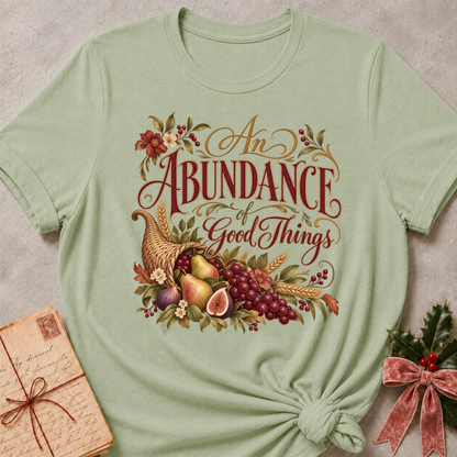 Sage relaxed fit tee with An Abundance of Good Things script and a woven cornucopia of pears, grapes, figs, wheat and autumn flowers