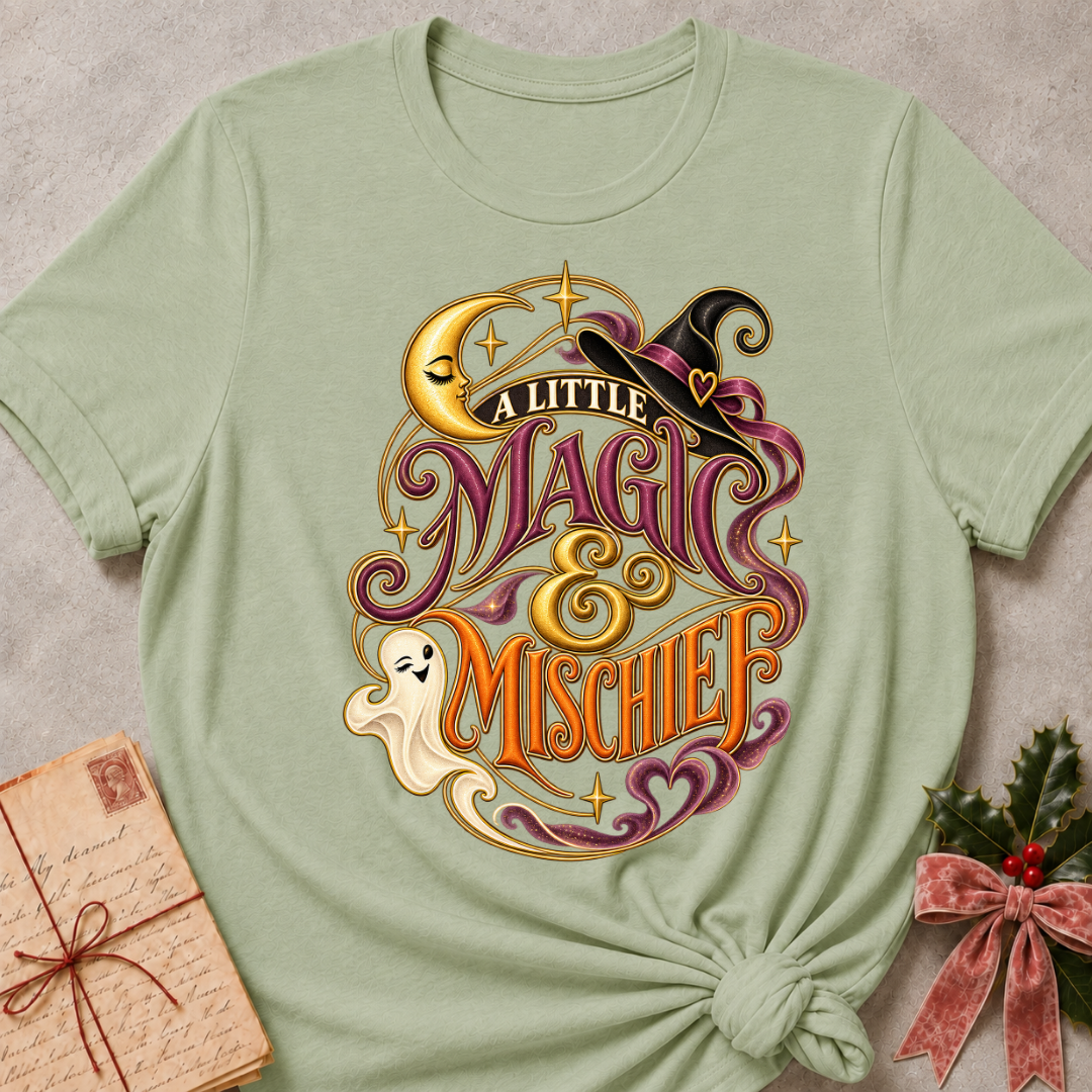 Sage A Little Magic & Mischief tee with a smiling ghost, sleepy crescent moon and witch's hat in gold and plum