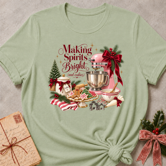 Sage green relaxed fit tee with a vintage Christmas baking scene and Making Spirits Bright lettering