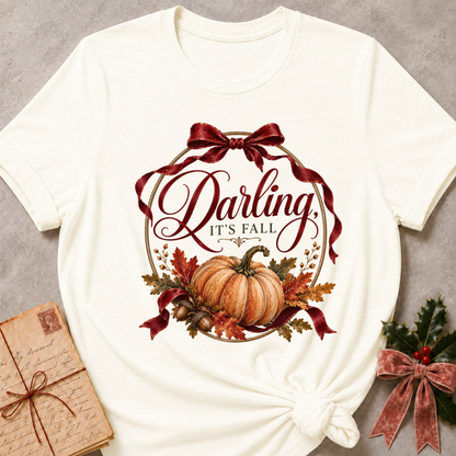 Vintage white women's relaxed tee with a vintage Darling It's Fall script design framed by a gold wreath, a burgundy ribbon bow, and a harvest pumpkin