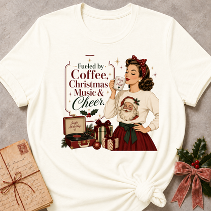 Vintage white relaxed fit tee with a retro Christmas pinup and Fueled By Coffee Christmas Music and Cheer lettering