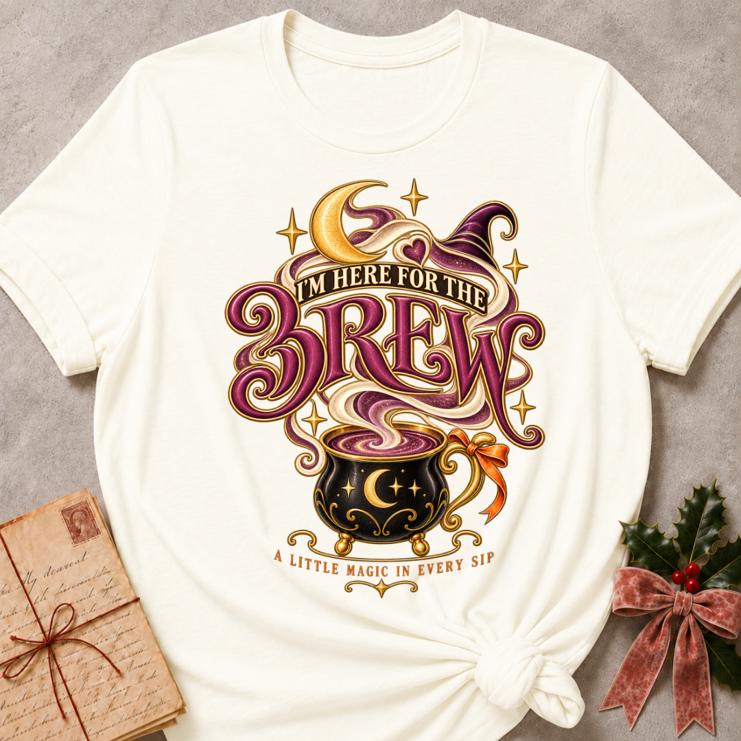 Vintage White I'm Here For The Brew tee with a moonlit cauldron mug, crescent moon and witch's hat in plum and gold