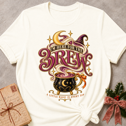 Vintage White I'm Here For The Brew tee with a moonlit cauldron mug, crescent moon and witch's hat in plum and gold