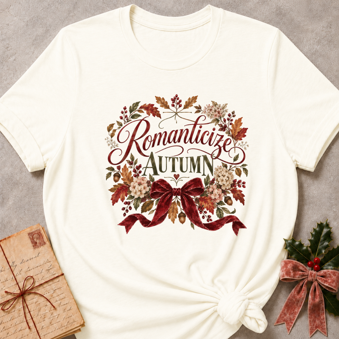 Vintage White relaxed fit tee with Romanticize Autumn script lettering, autumn leaves, cream blooms and a burgundy velvet bow